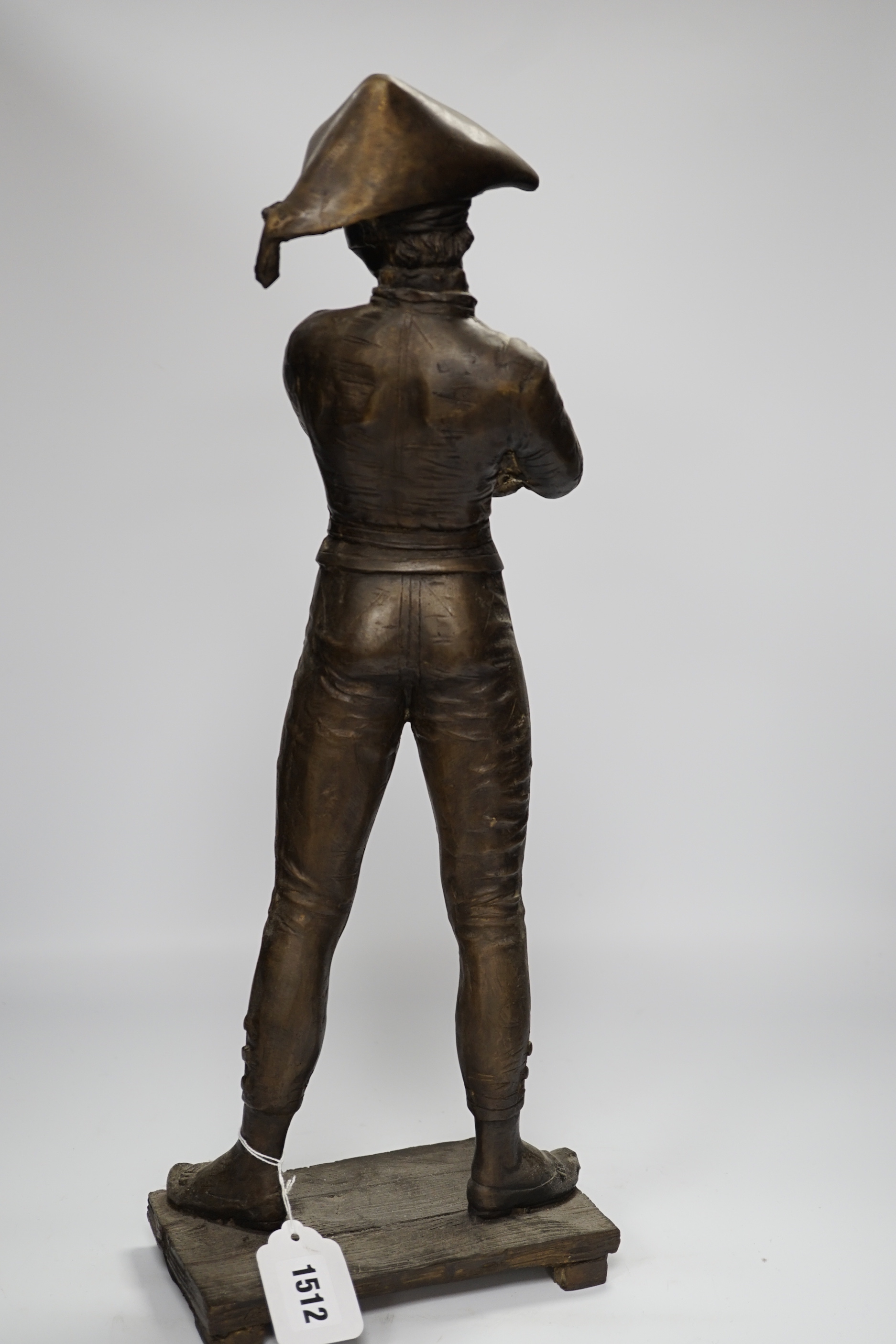 A tall bronze figure of harlequin, 52cm high
